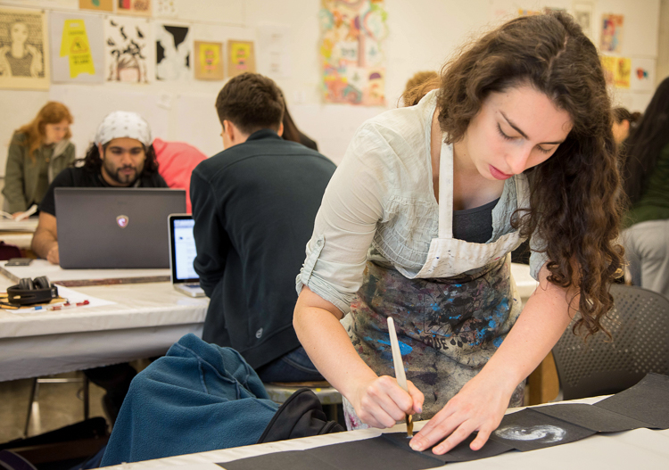 Student working on project in a bookmaking course