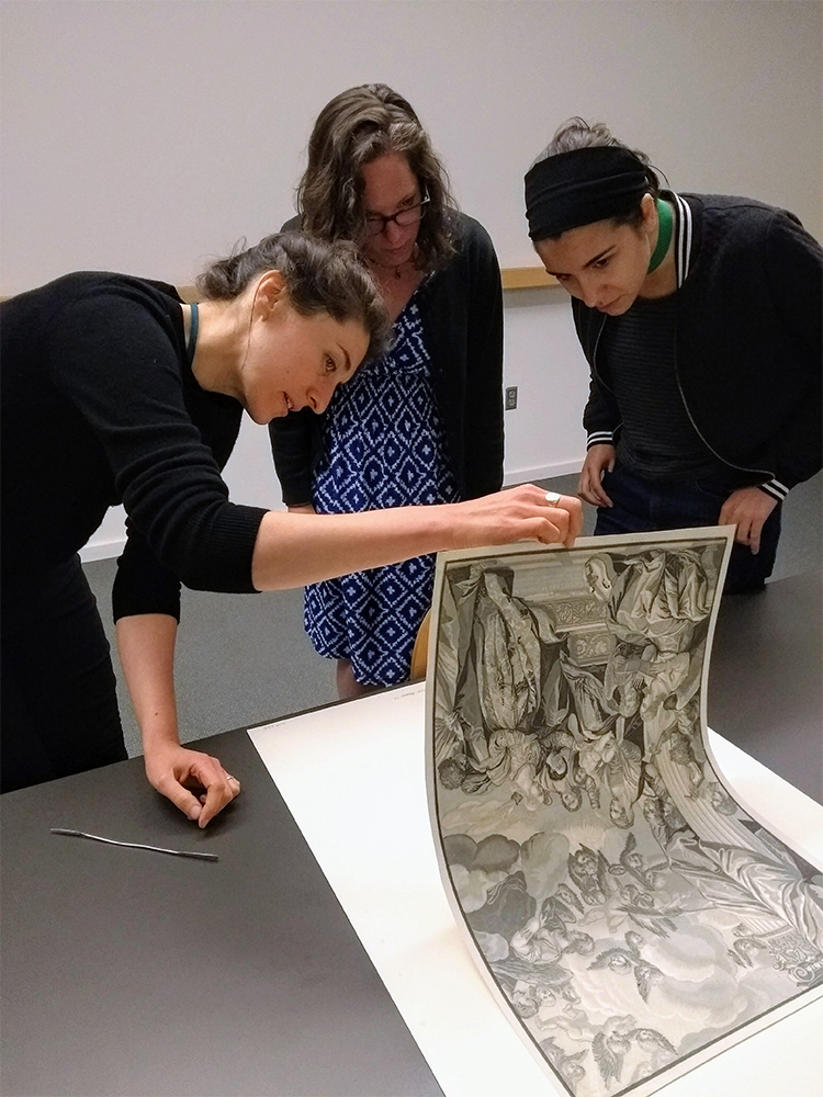 Claire Kenny examining prints with some students