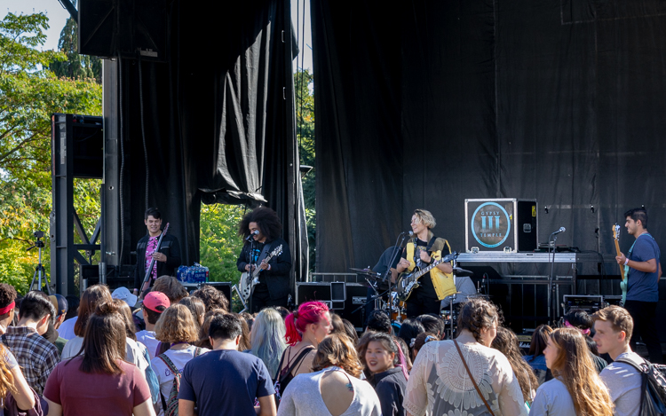 Rock/pop musicians playing on stage in front of a crowd of students at UW's Fall Fling