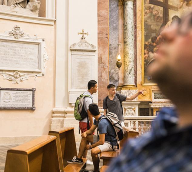 Image of four students studying art in a museum