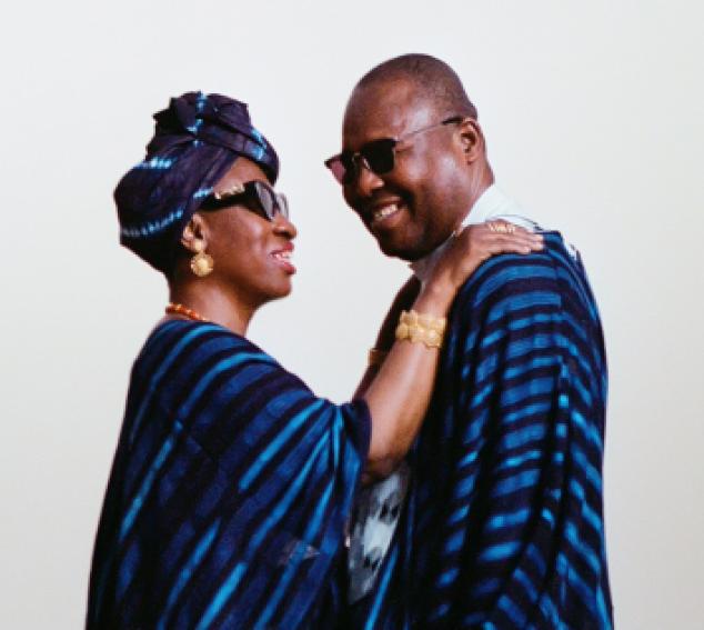 Two individuals in blue embrace one another