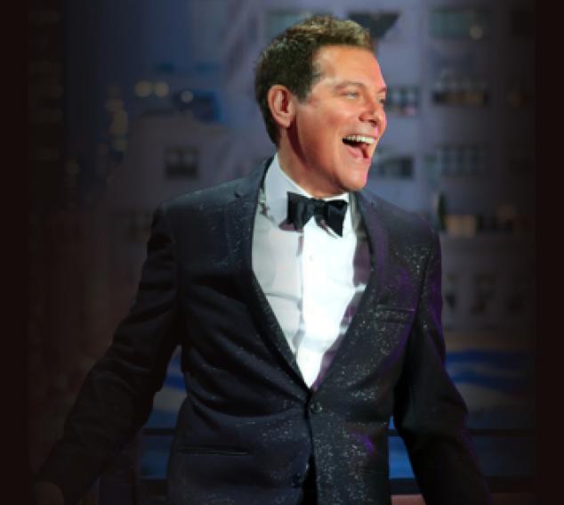 Michael Feinstein, a male vocalist in a black and white tux